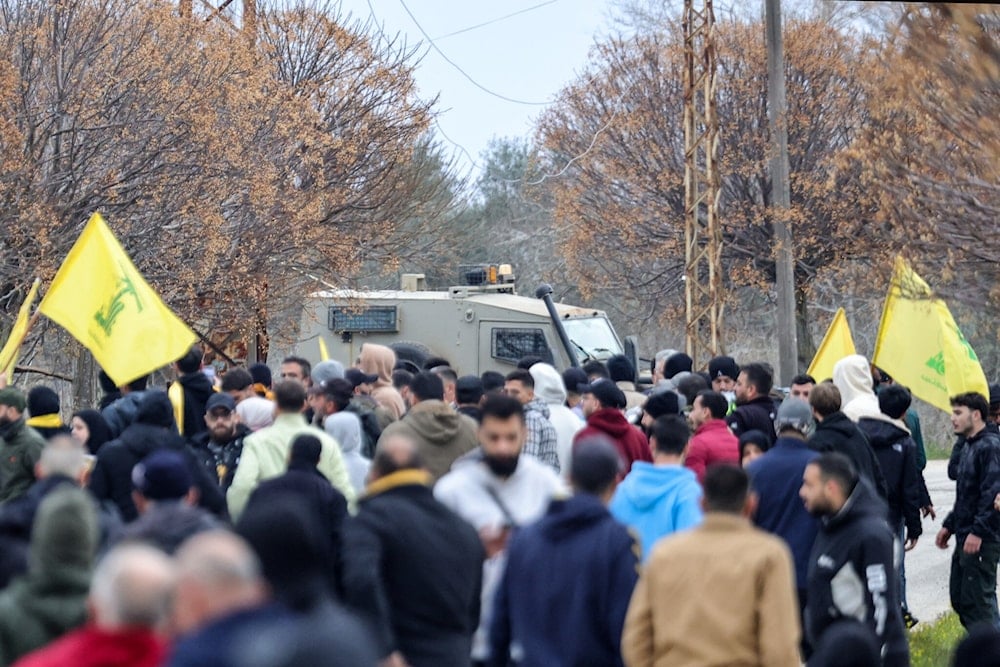 South Lebanese civilians stand near an Israeli military vehicle in Borj El Molouk on January 26, 2025. (AFP)