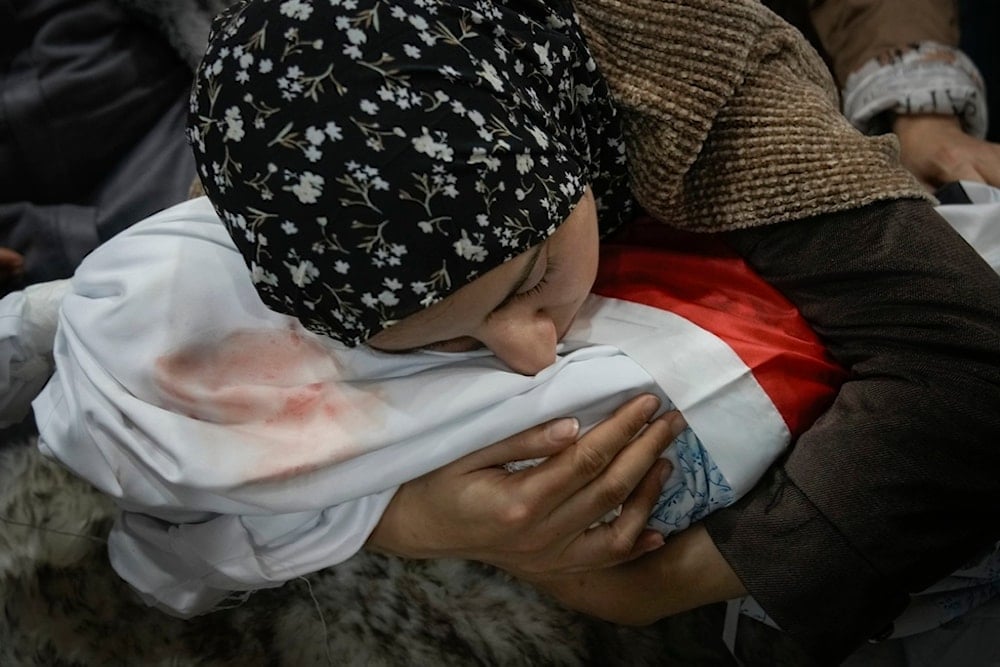 Tima Al-Khatib weeps over the body of her 2-year-old daughter Laila during her funeral in the West Bank village of al-Shuhada, near Jenin, Sunday, January 26, 2025 (AP)