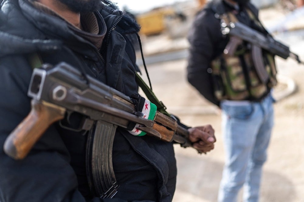 Members of the new Syrian security forces stand outside a security building, in Nawa, near Daraa, Syria, Jan. 4, 2025 (AP)