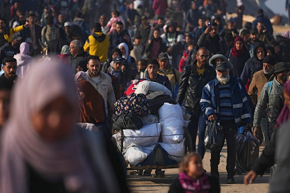 Displaced Palestinians walk on a road to return to their homes in the northern Gaza Strip, Tuesday, Jan. 28, 2025. (AP)