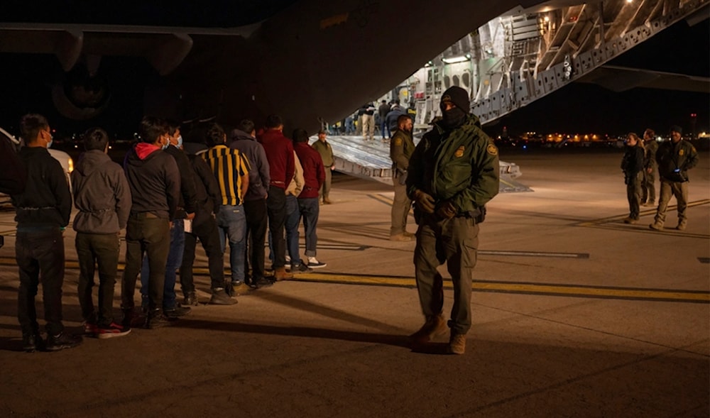 This photo provided by the US Dept. of Defense, US Customs and Border Protection Agents guide undocumented immigrants onboard a C-17 Globemaster III at the Tucson International Airport, Ariz., Jan. 23, 2025. (AP)