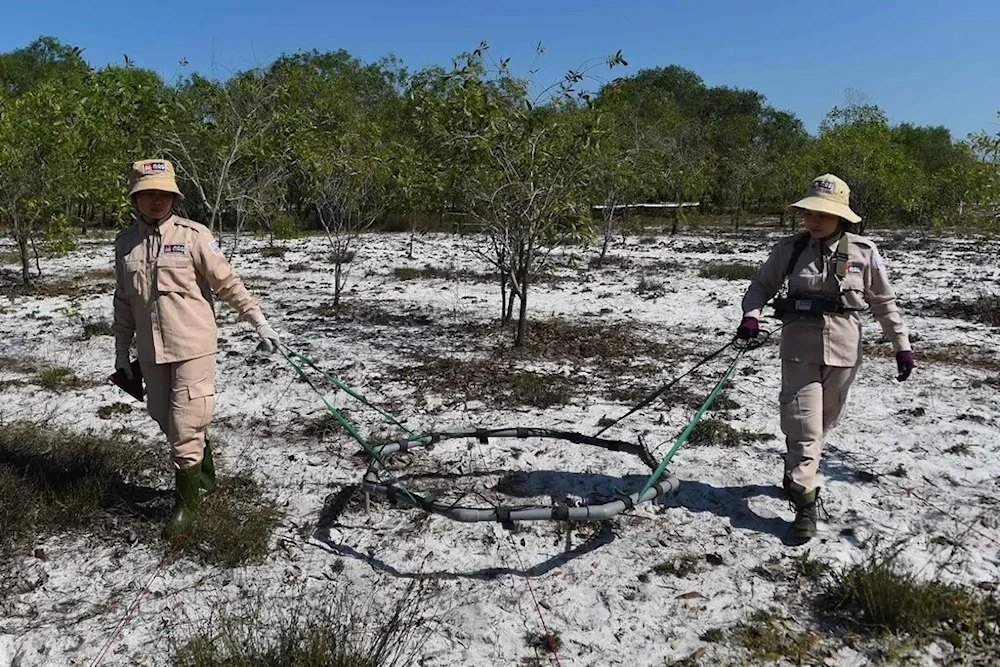  Members of a demining team look for unexploded ordnance in Quang Tri Province Vietnam, in 2020. (AFP via Getty Images)