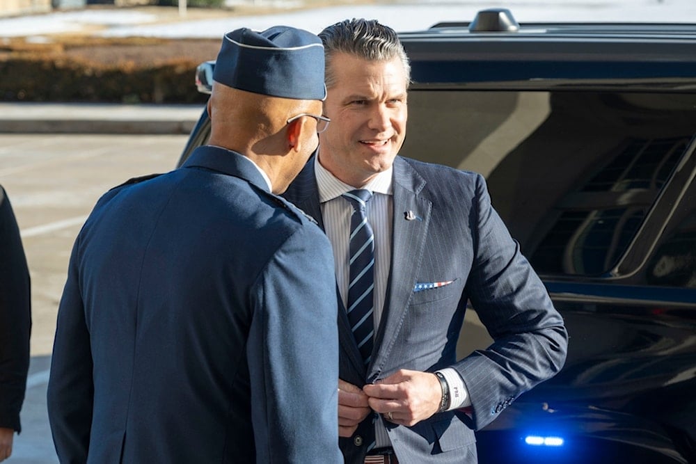 Defense Secretary Pete Hegseth, right, and Chairman of the Joint Chiefs of Staff Gen. Charles Q. Brown Jr., talk after Hegseth arrived at the Pentagon, Monday, Jan. 27, 2025, in Washington (AP)