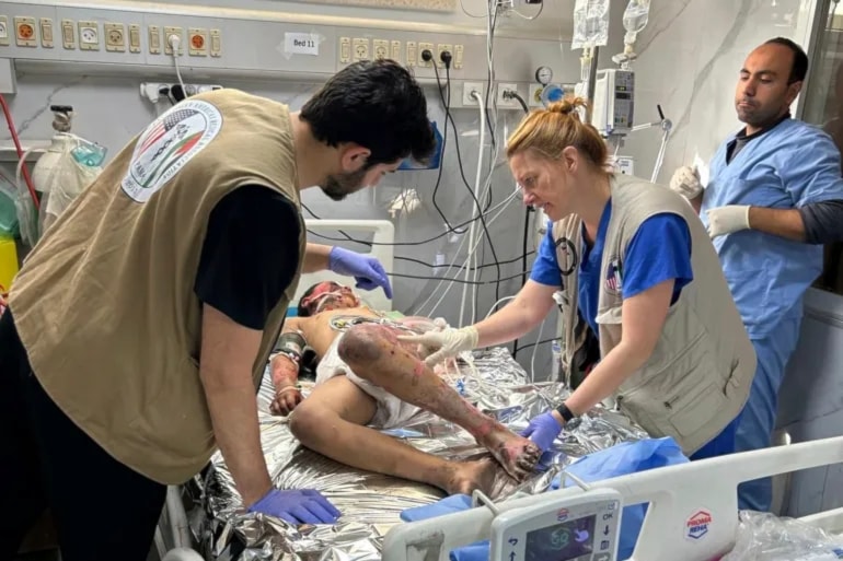 Monica Johnston RN, burn and wound care nurse from Portland, Oregon, with the Palestinian American Medical Association, monitors a Palestinian child who sustained major burns due to a brutal Israeli airstrike on May 8, 2024, in Khan Younis, Gaza. (AP)