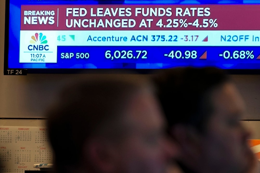 Screens on the floor of the New York Stock Exchange display news about the Federal Reserve interest rate in New York, Wednesday, Jan. 29, 2025. (AP Photo/Seth Wenig)