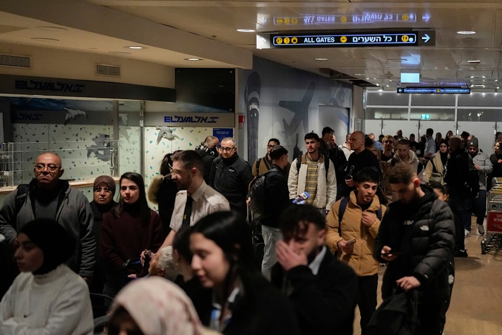 People rush toward a shelter after airstrike sirens sounded off in Ben Gurion Airport, near Tel Aviv, Palestine, early Friday, Jan. 3, 2024. (AP Photo/Matias Delacroix)