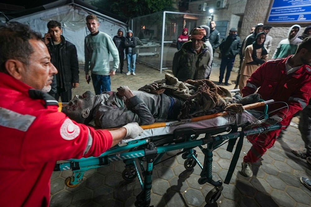 A wounded man is brought to al-Aqsa Martyrs Hospital following Israeli army airstrikes in the Nuseirat and Maghazi camps, in the central Gaza Strip, Thursday, Jan. 2, 2025. (AP)