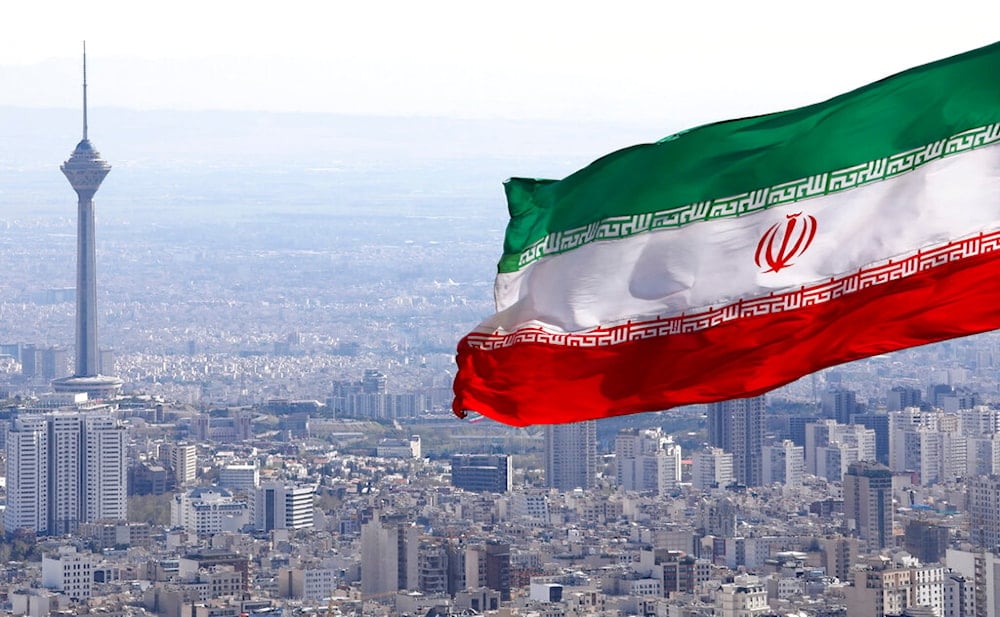  In this March 31, 2020, file photo, Iran's national flag waves as Milad telecommunications tower and buildings are seen in Tehran, Iran. (AP)