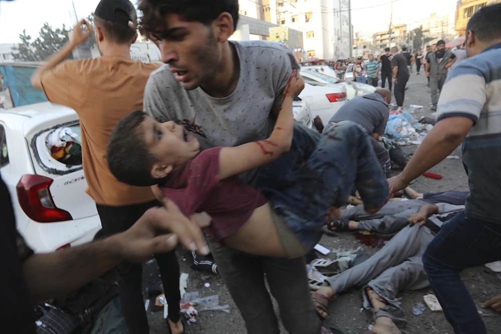 An injured Palestinian child is carried from the ground following an Israeli outside the entrance of the al-Shifa hospital in Gaza City, Friday November 3, 2023. (AP)