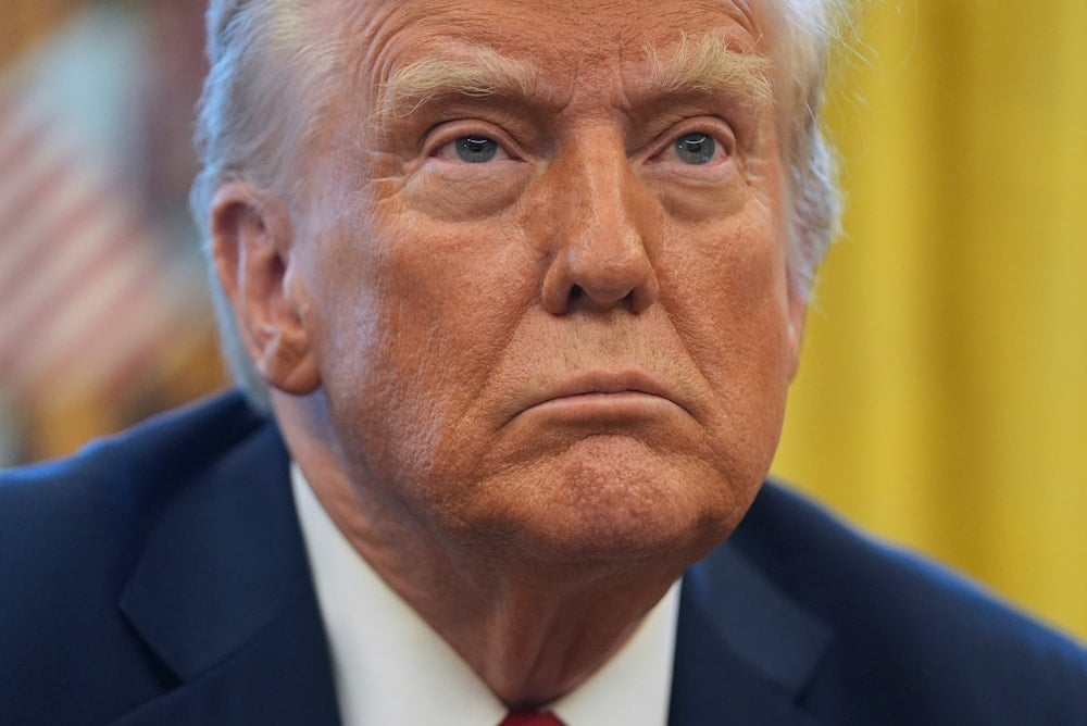 President Donald Trump listens to a question as he signs executive orders in the Oval Office at the White House, on January 30, 2025, in Washington. (AP)