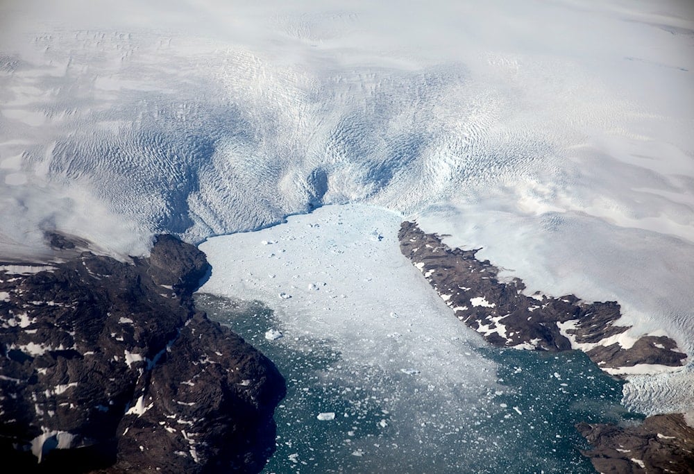 A glacier calves icebergs into a fjord off the Greenland ice sheet in southeastern Greenland, August 3, 2017. (AP)