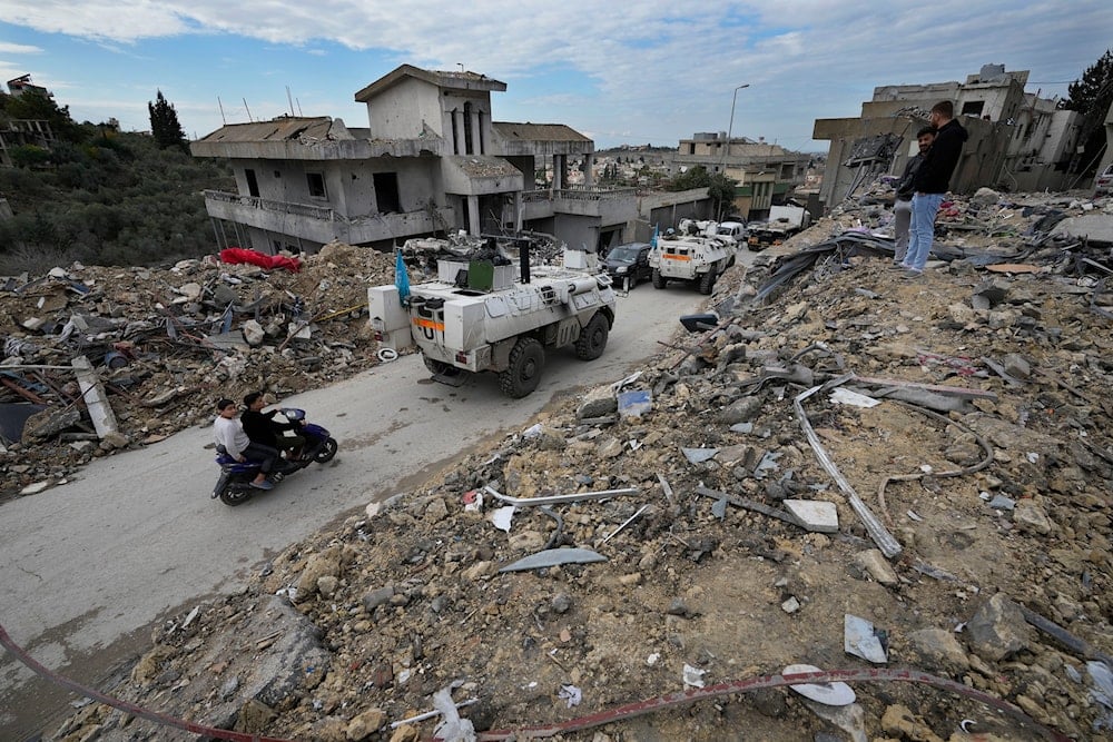 South Korean U.N peacekeeper drives past destroyed buildings in Chehabiyeh village, southern Lebanon, on November 28, 2024. (AP)