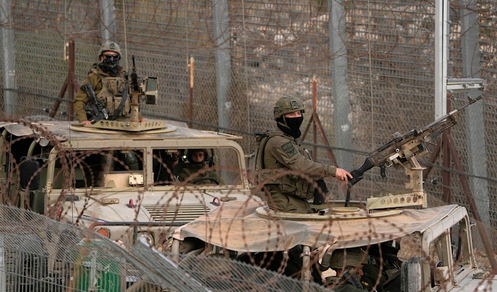 Israeli soldiers stand on armored vehicles after crossing the security fence near the 'Disengagement Line' that separates the occupied Golan Heights from Syria, in the town of Majdal Shams, Saturday, Dec. 21, 2024. (AP)