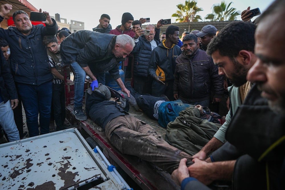 The bodies of men killed in an Israeli army strike targeting a car are brought to Al-Aqsa Martyrs hospital in Deir al-Balah, central Gaza Strip, on January 3, 2025. (AP)