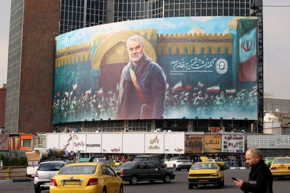 A large panel showing an illustration of martyr Soleimani in Tehran’s Valiasr Square. (AFP)