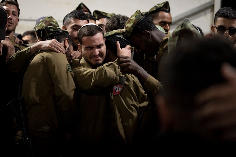 Israeli occupation forces soldiers at the grave of a sergeant killed in the Gaza Strip during his funeral at Mt. Herzl military cemetery in occupied al-Quds, occupied Palestine, Wednesday, November 20, 2024 (AP)