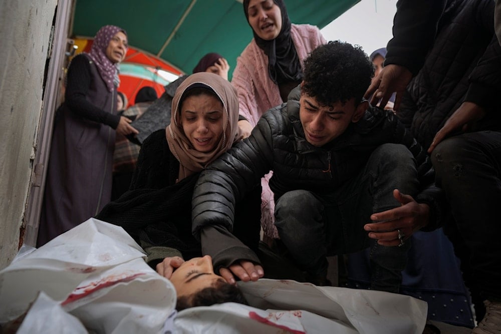 Relatives of Mohammed Al Mabhouh,15, who was killed by the Israeli bombardment of the Gaza Strip, mourn over his body at Al-Aqsa Martyrs Hospital in Deir al-Balah, Sunday, Jan. 5, 2025. (AP)