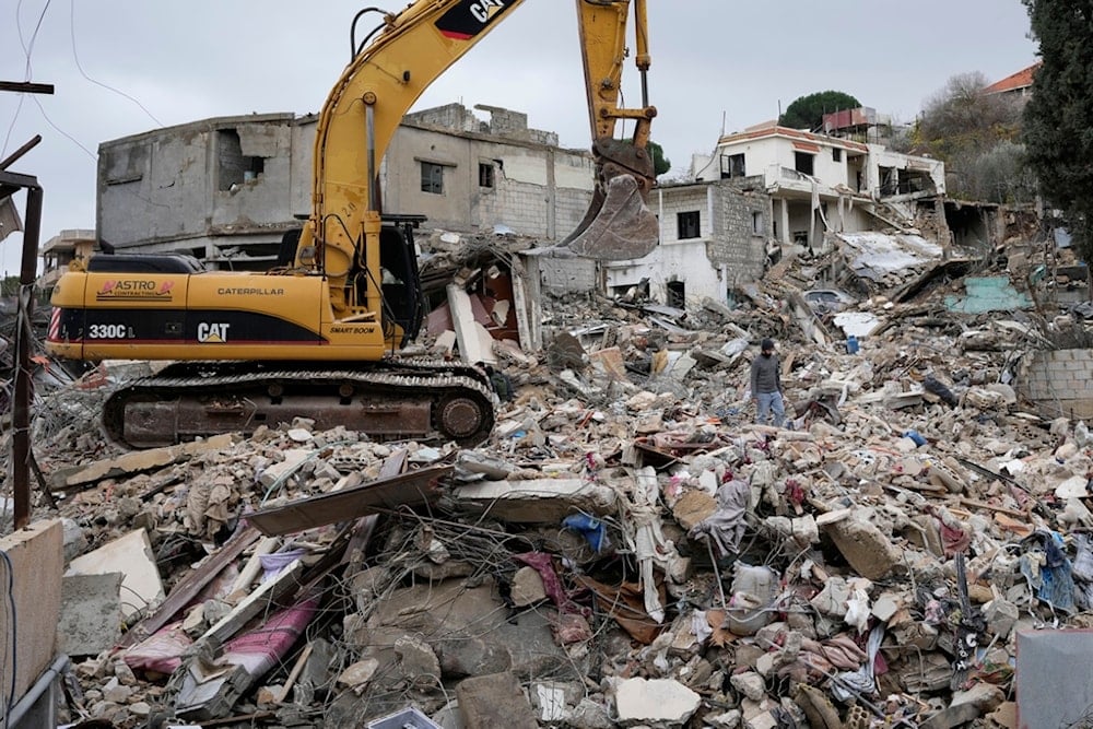 Rescuers use an excavator as they search for dead bodies through the rubble of a destroyed house, following a ceasefire between the Israeli occupation and Lebanon that went into effect on Wednesday, Nov. 27, 2024, in Ainata, south Lebanon (AP)