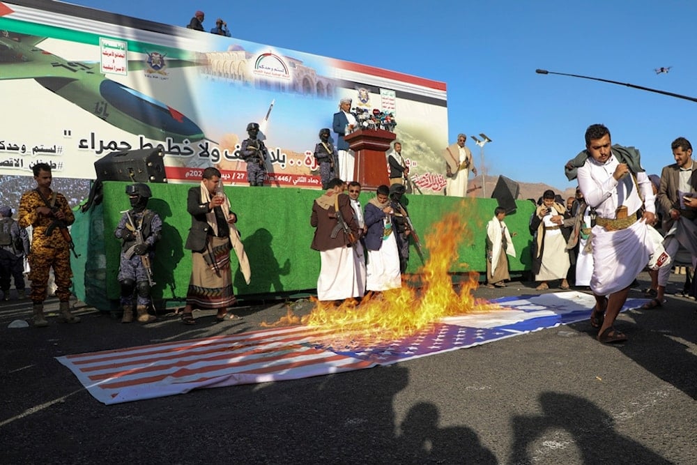 Yemenis burn Israeli and American flags during an anti-Israeli, US rally in Sanaa, Yemen, Friday, Dec. 27, 2024 (AP)