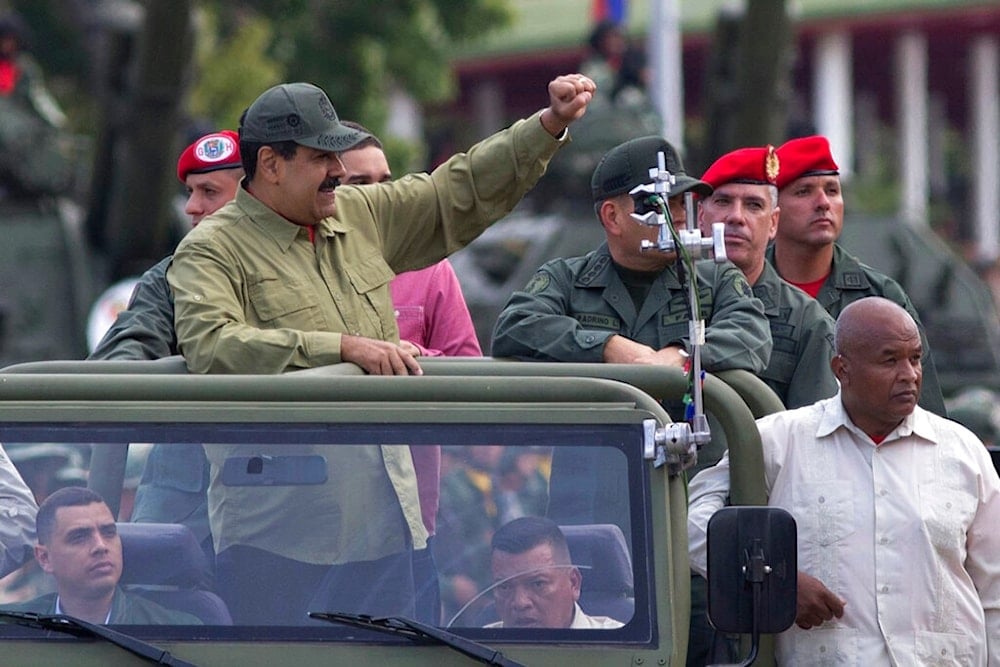 In this April 13, 2018, file photo, Defense Minister Vladimir Padrino Lopez, center right face obscured, accompanies Venezuela's President Nicolas Maduro as they arrive in Caracas, Venezuela (AP)