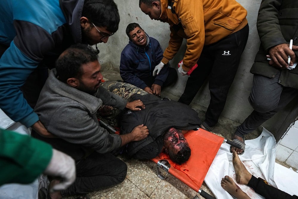 Relatives mourn over the body of a man killed in Israeli army airstrikes, at Al-Aqsa Martyrs Hospital in Deir al-Balah, the central Gaza Strip, on January 4, 2025. (AP)