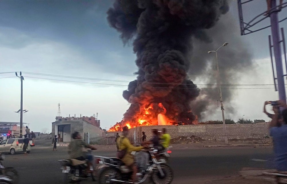 A large fire and plume of smoke is visible in the port city of Hodeida, Yemen, following an Israeli airstrike on Sunday, Sept. 29, 2024 (AP)