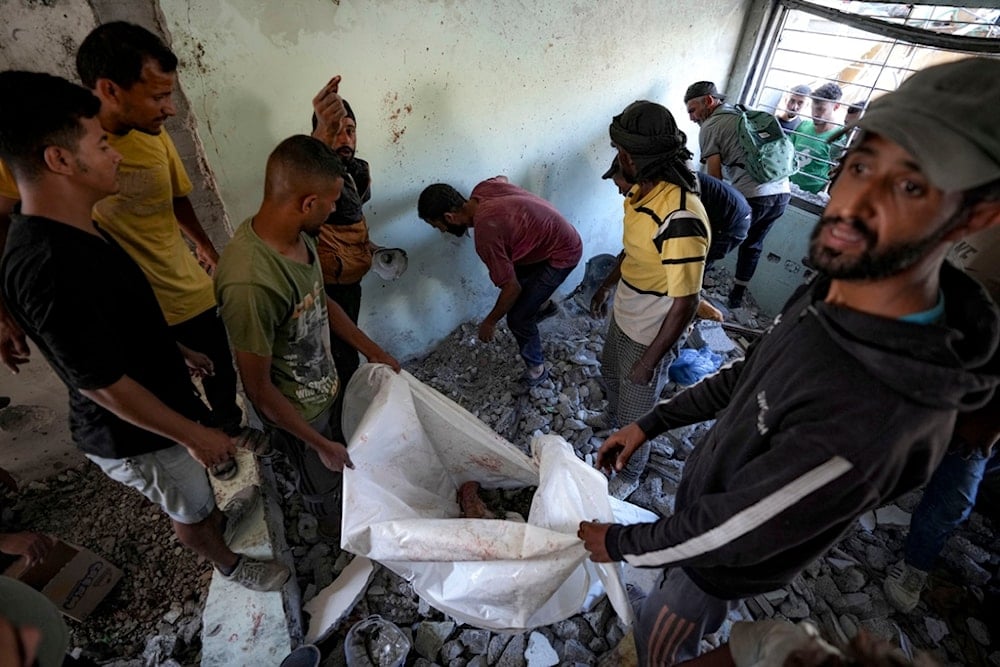 Palestinians search for the remains of their relatives killed in an Israeli bombardment of a school in Deir al-Balah, central Gaza Strip, Thursday, October 10, 2024. (AP)