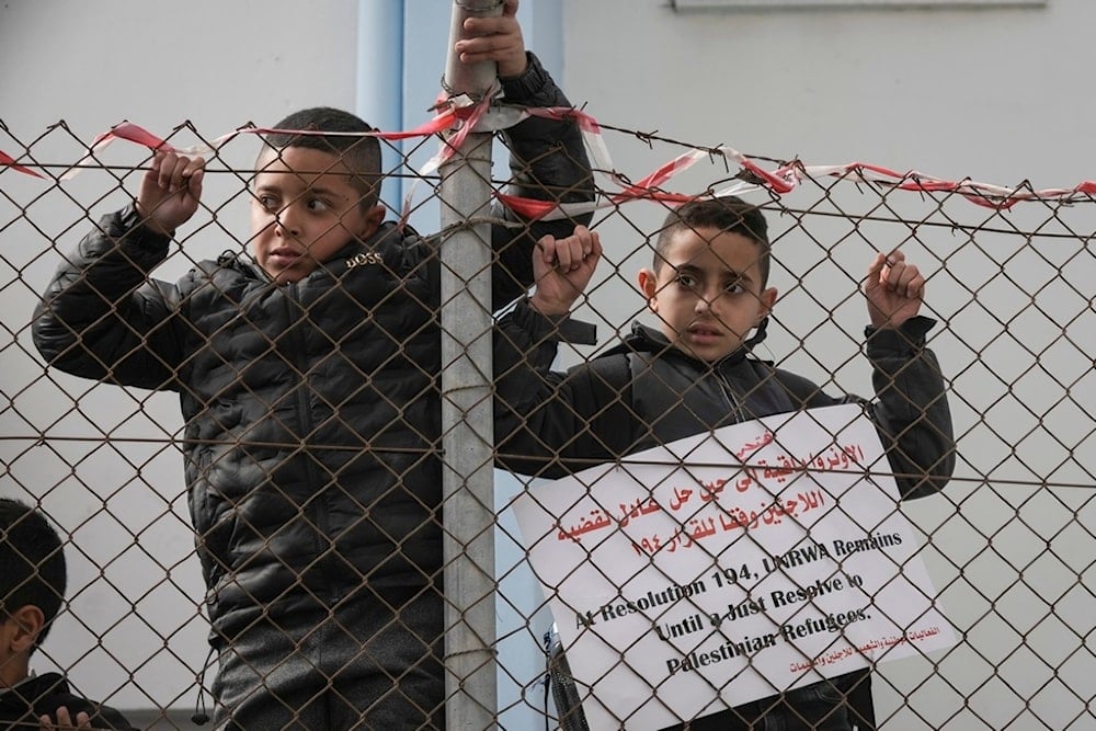 Palestinian youth demonstrate in front a UNRWA (UN Agency for Palestinian Refugees) clinic at the Qalandia refugee camp, to protest the Israeli parliament decision preventing the agency to continue its work, the occupied West Bank, Nov. 2024 (AP)