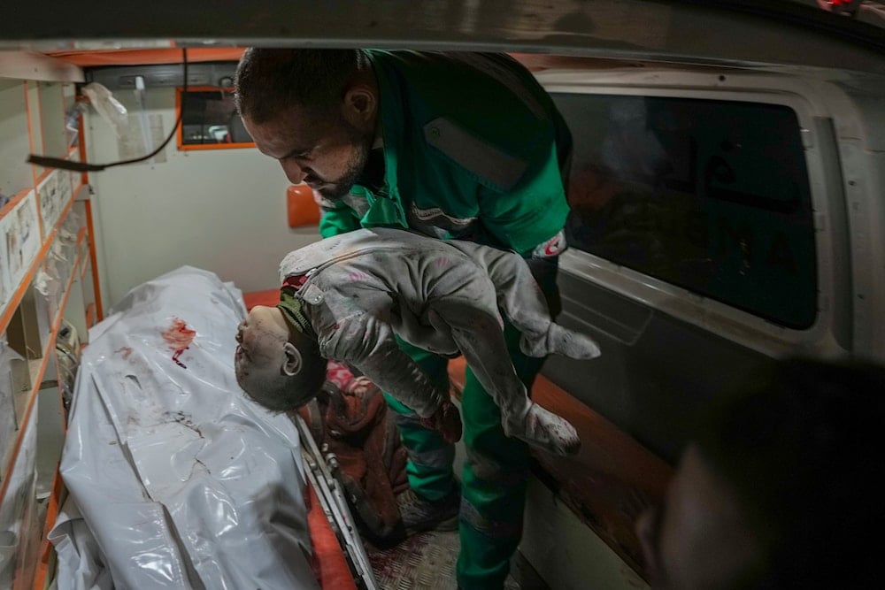 A dead child is brought to Al-Aqsa Martyrs Hospital after Israeli army airstrikes targeted the Nuseirat and Maghazi camps in Deir al-Balah, central Gaza Strip, on January 2, 2025. (AP)