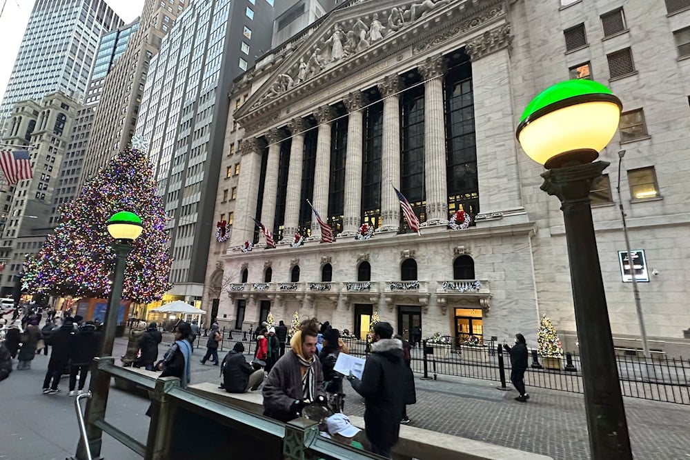 Lights marking the entrance to a subway station frame the New York Stock Exchange in New York's Financial District on December 23, 2024. (AP)