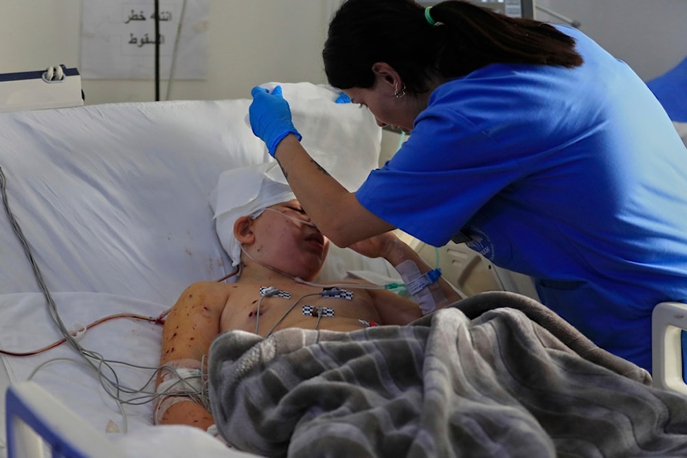A nurse cares for a boy who was injured in an Israeli airstrike on Monday evening in Nabatiyeh town, South Lebanon Tuesday, September 16, 2025. (AP Photo/Mohammad Zaatari)