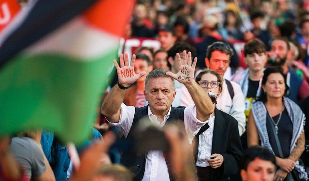 A man shows his hands bearing graffiti in Italian reading 'Not in my name' during a pro-Global Sumud Flotilla demonstration in downtown Rome, Thursday, Sept. 25, 2025. (AP)
