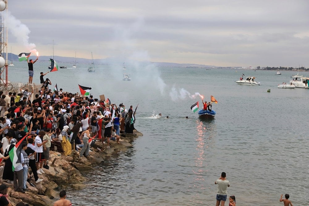 People gather to show support for the Global Sumud Flotilla ahead of its scheduled departure to deliver aid to Gaza amidst the Israeli blockade on the Palestinian territory, in Sidi Bou Said port in Tunis, Tunisia, Wednesday, September 10, 2025 (AP)