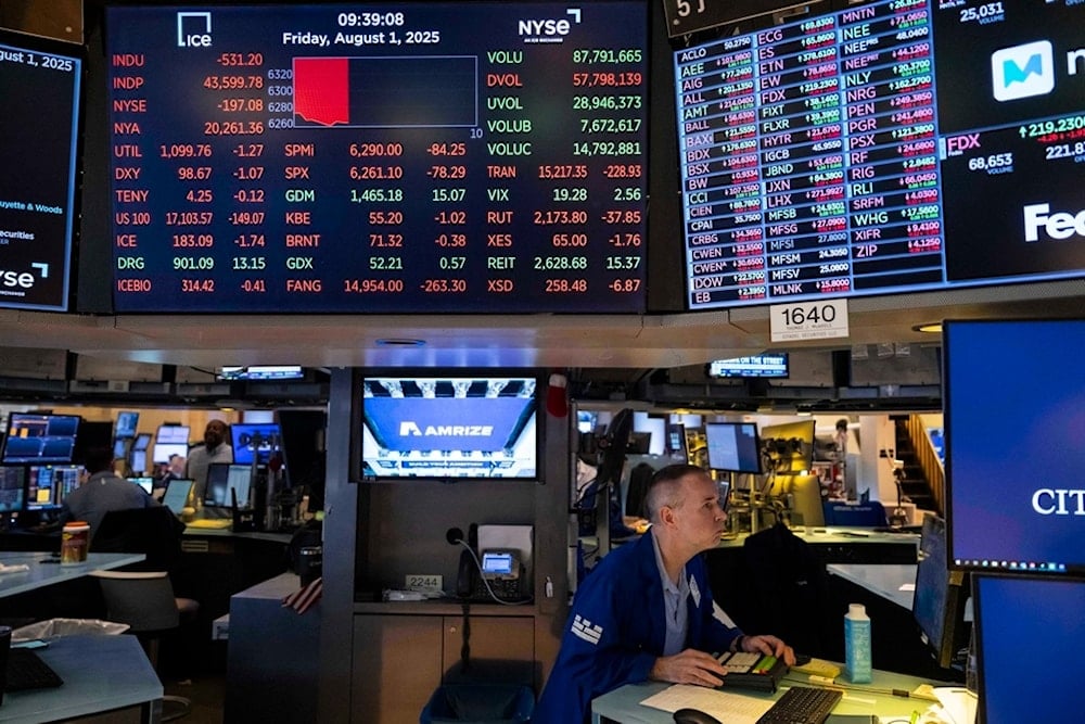 A screen shows stock prices on the floor of the New York Stock Exchange, Friday, August 1, 2025, in New York. (AP Photo/Yuki Iwamura)