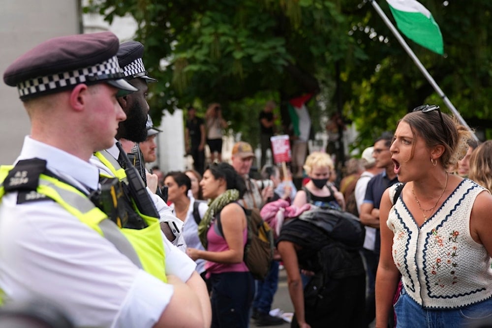 Protesters argue with police officers during a protest to support Palestine Action in London, Saturday, September 6, 2025 (AP)
