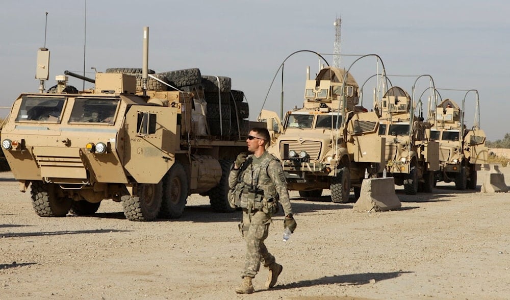 A US Army soldier with 1st Brigade, 1st Cavalry Division walks past military armored vehicles that are ready to be shipped out of Iraq at Contingency Operating Site Kalsu, Iraq, Dec. 5, 2011.  (AP)