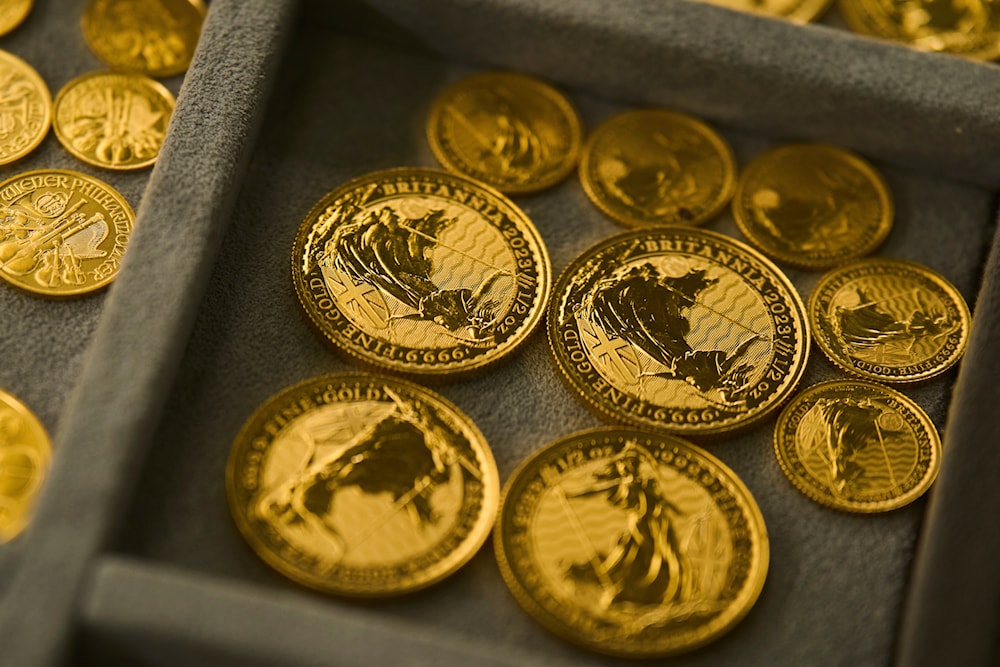 Gold eases after record high, heads for eighth straight weekly gain