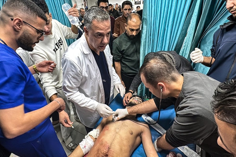 Dr. Hossam Abu Safieh supervises the treatment of an injured man on November 21 2024 (AFP / Getty Images)