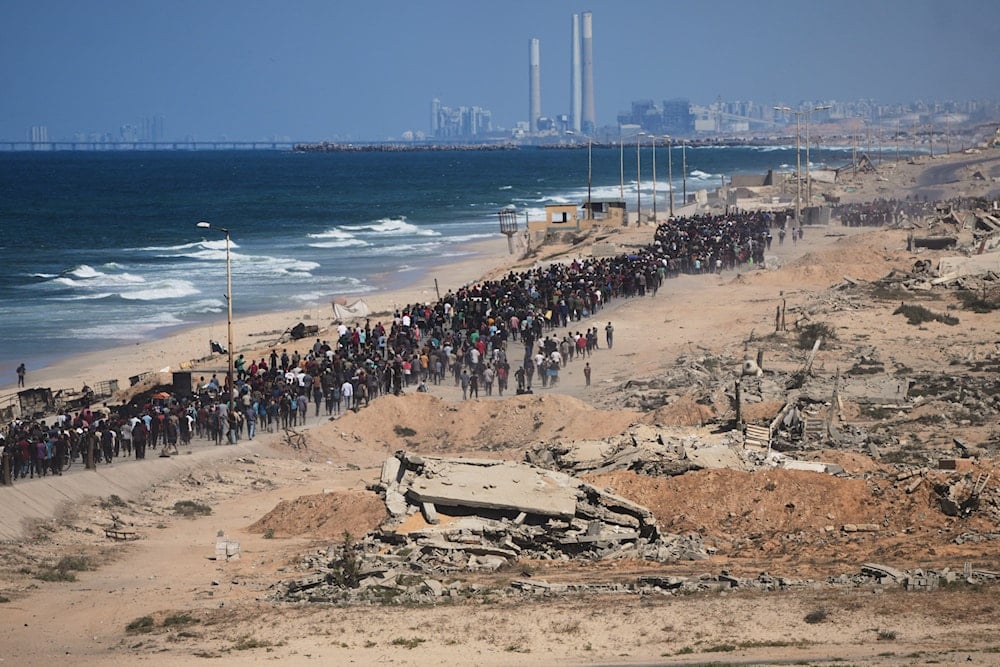 Displaced Palestinians walk along the coastal road near Wadi Gaza in the central Gaza Strip, moving toward northern Gaza, Friday, Oct. 10, 2025 (AP)