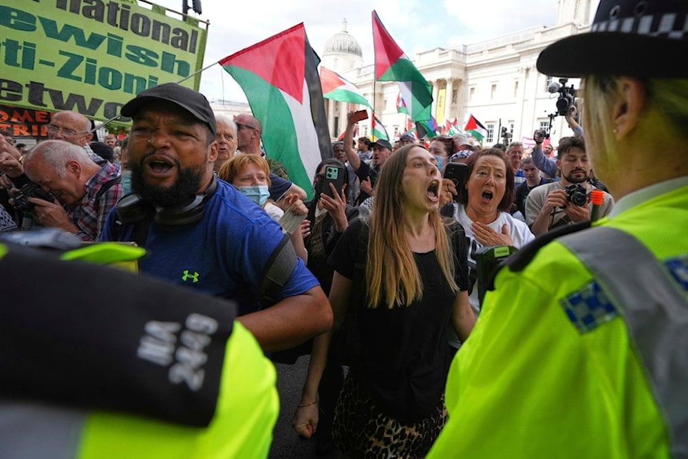 Demonstrators shout as they reach a police line during a protest by Palestine Action group in London, Monday, June 23, 2025. (AP Photo/Frank Augstein)
