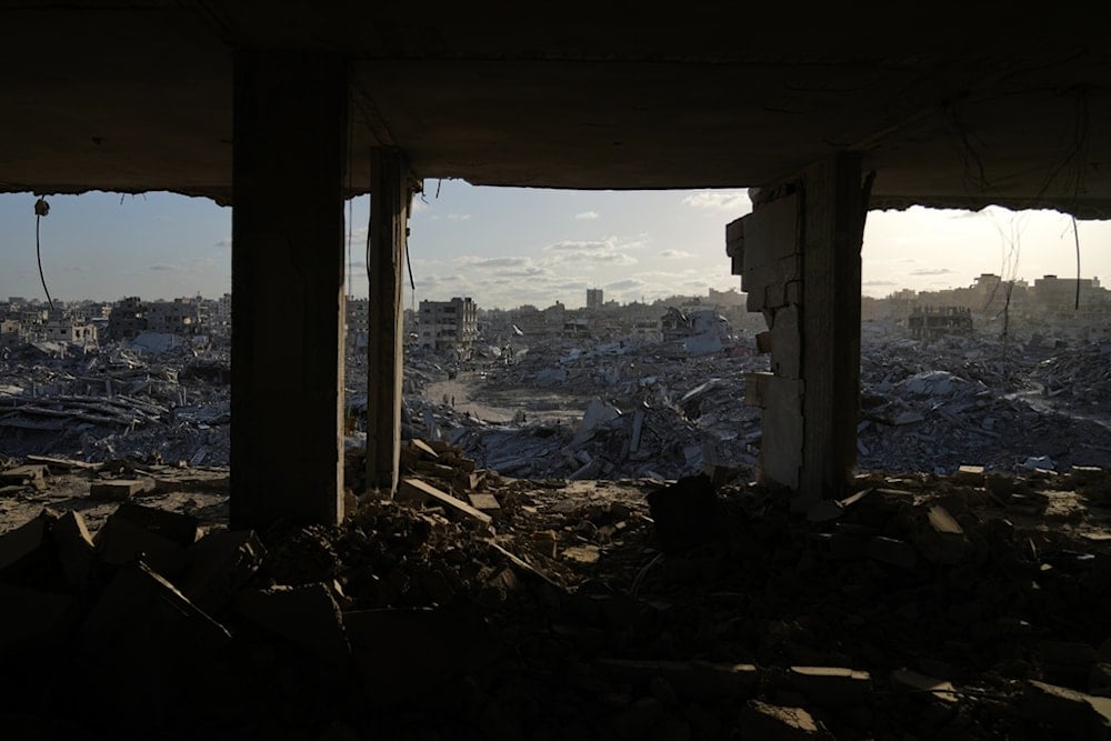 Displaced Palestinians walk amid destroyed buildings in the heavily damaged Sheikh Radwan neighborhood in Gaza City, Saturday, Oct. 11, 2025. (AP)