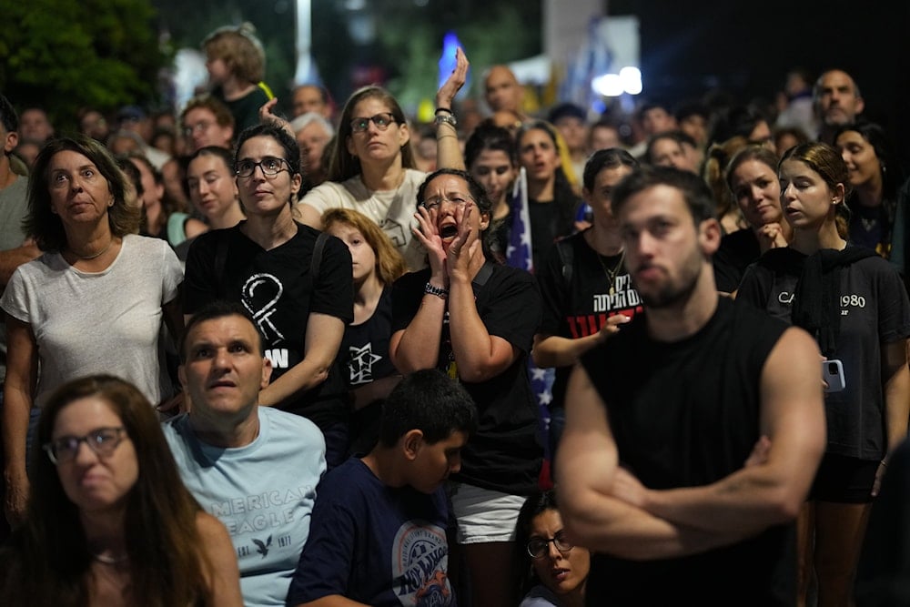 People react during a rally in support of hostages kidnapped by Hamas, at a plaza known as hostages square, in Tel Aviv, Israel, Saturday, Oct. 11, 2025, ahead of the expected release of the hostages held in the Gaza Strip. (AP Photo/Francisco Seco)