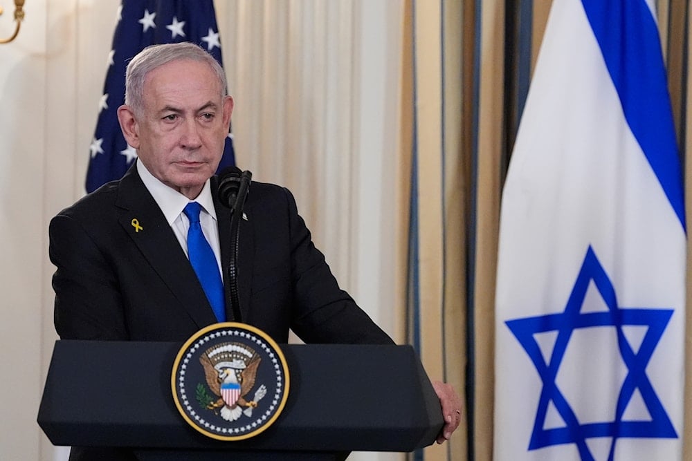 Israel's Prime Minister Benjamin Netanyahu listens as President Donald Trump speaks during a news conference in the State Dining Room of the White House, on September 29, 2025, in Washington. (AP Photo/Alex Brandon)