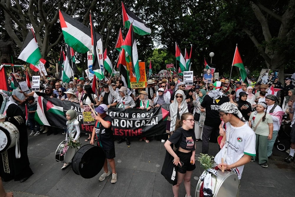 People begin to march during a rally in Sydney, Australia, Sunday, Oct. 12, 2025, supporting Palestinians in Gaza. (AP Photo/Rick Rycroft)