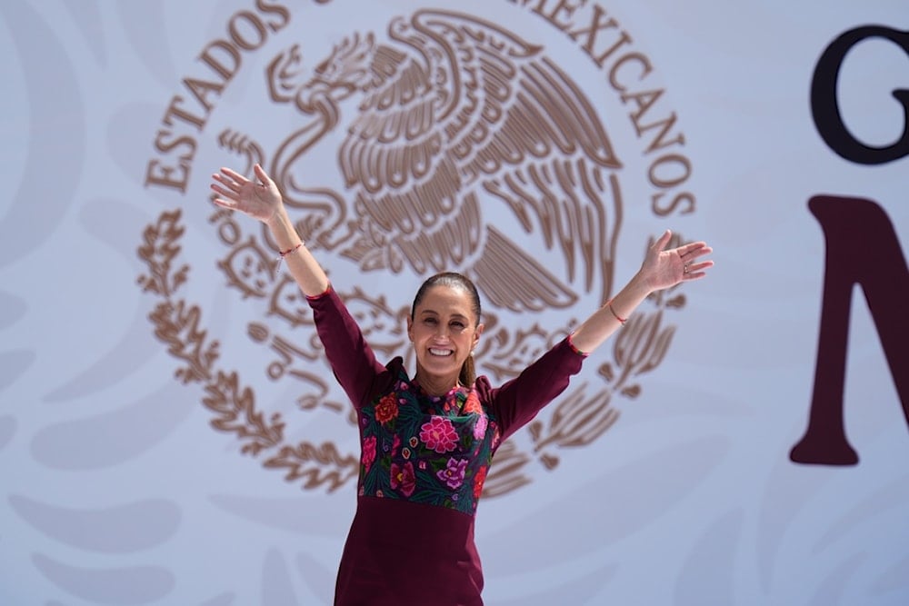 President Claudia Sheinbaum waves to supporters at the Zocalo, Mexico City's main square, at an event marking her first year in office, Sunday, October 5, 2025. (AP Photo/Fernando Llano)