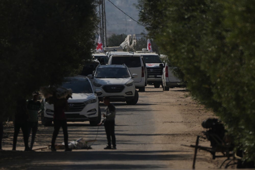 Hamas and Red Cross vehicles arrive at the site for the handover of Israeli hostages in Khan Younis, southern Gaza Strip, on October 13, 2025. (AP Photo/Abdel Kareem Hana)