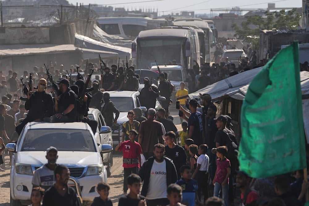 Hamas fighters escort buses carrying freed Palestinian prisoners arriving in the Gaza Strip after their release from Israeli jails, in Khan Younis, southern Gaza Strip, Monday, October 13, 2025 (AP)