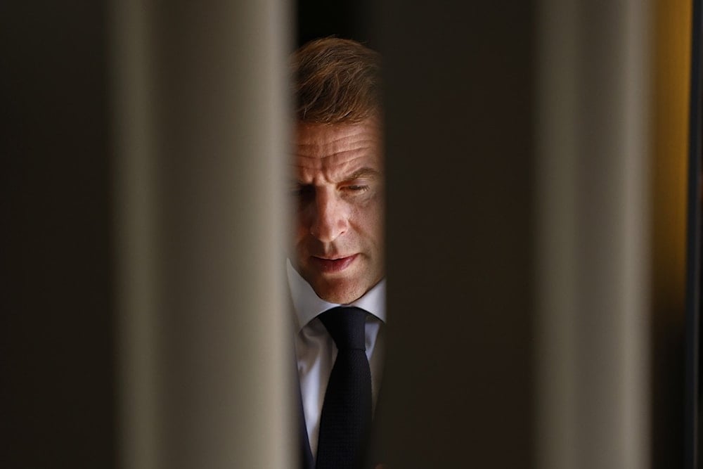 French President Emmanuel Macron waits for Palestinian President Mahmoud Abbas on the sidelines of the Gaza International Peace Summit, in Sharm el-Sheikh, Egypt, Monday, October13 2025. (Yoan Valat, Pool photo via AP)