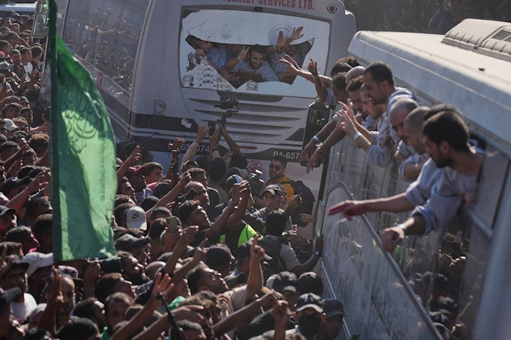 People gather to greet freed Palestinian prisoners arriving on buses in the Gaza Strip, outside Nasser Hospital in Khan Younis, southern Gaza Strip, Monday, October 13, 2025 (AP)