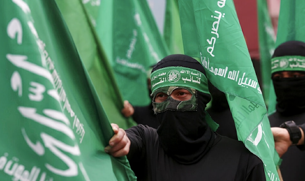 Masked Hamas fighters wave their flags during a protest against the Mideast plan announced by US President Donald Trump at the main road in Gaza City on February 14, 2020. (AP)